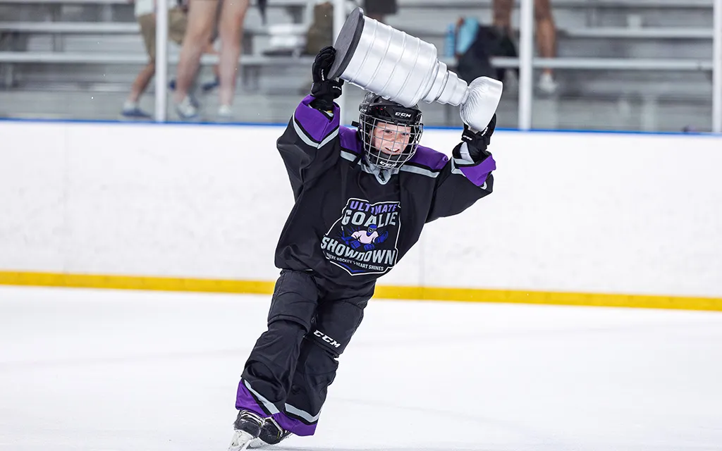 WyattStowell lifts the Tino Cup after winning the tournament at Ultimate Goalie Showdown